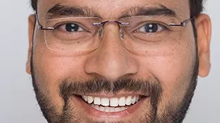 A Fronius employee smiles at the camera