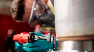 Welder cleans a surface